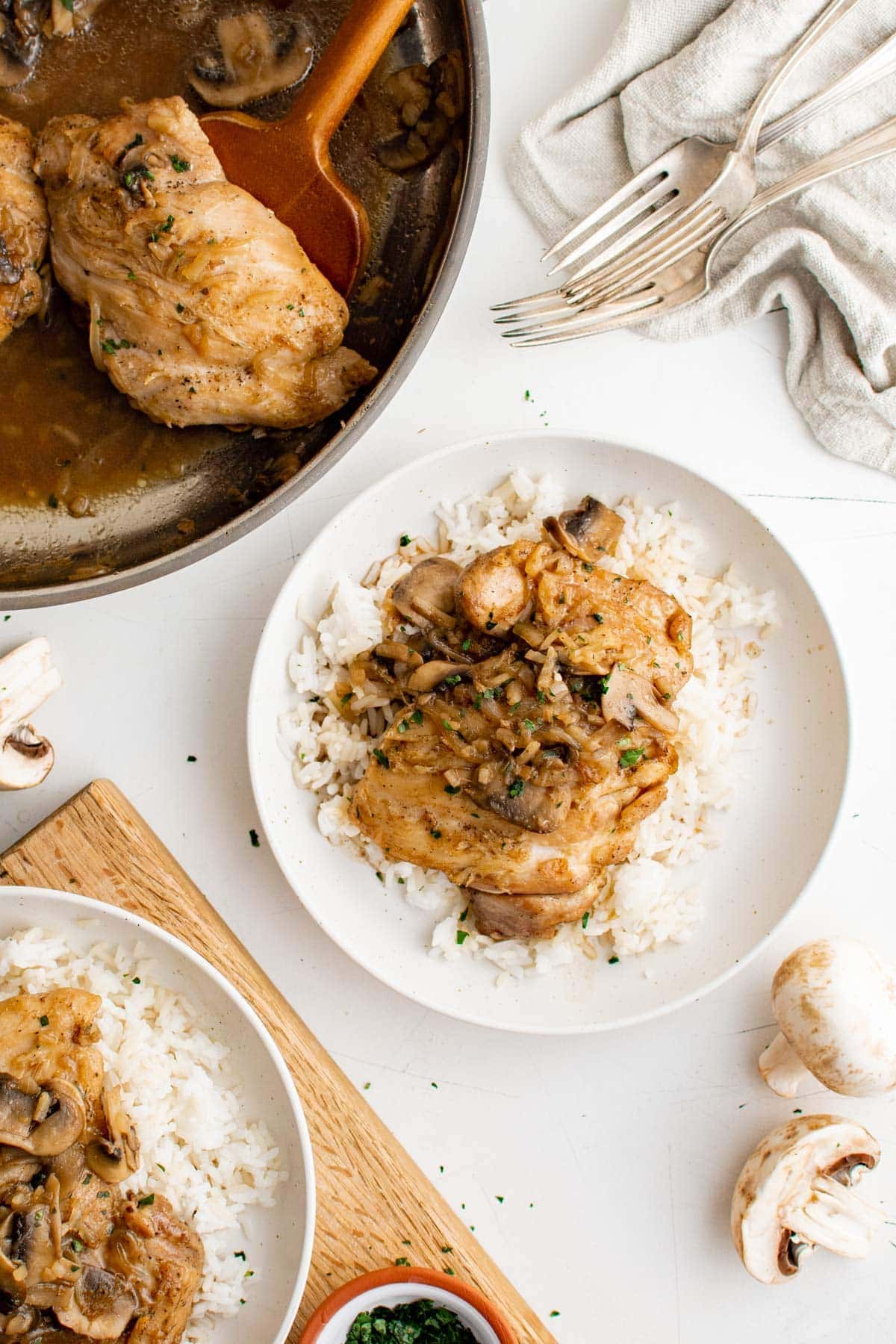 French onion chicken and gravy on a white plate with rice. 