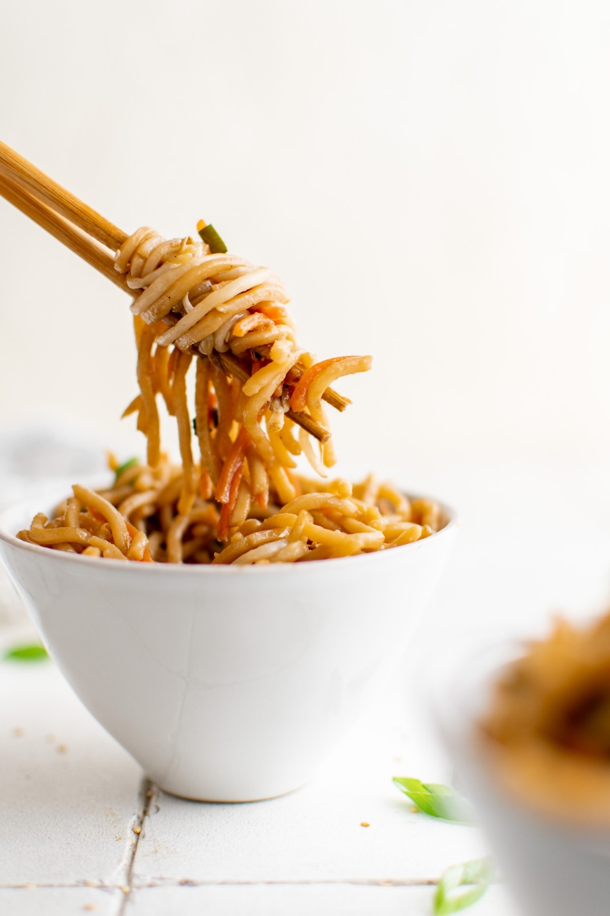 Pan Fried Noodles in a white bowl with chopsticks. 