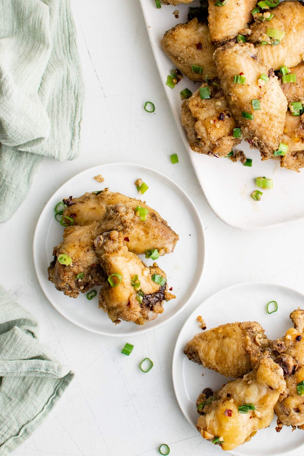 Salt and Pepper Chicken Wings on small white plates.