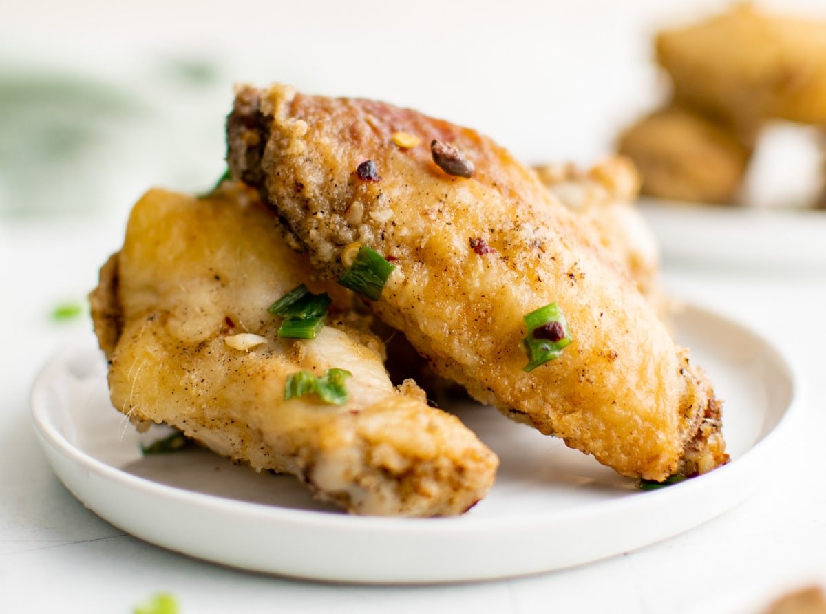 Chicken wings on a white plate.