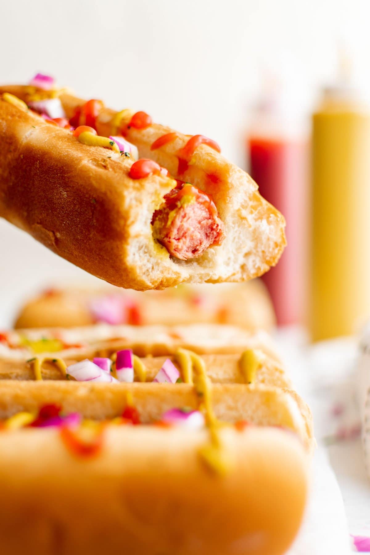 A hot dog with a bite taken out of it.