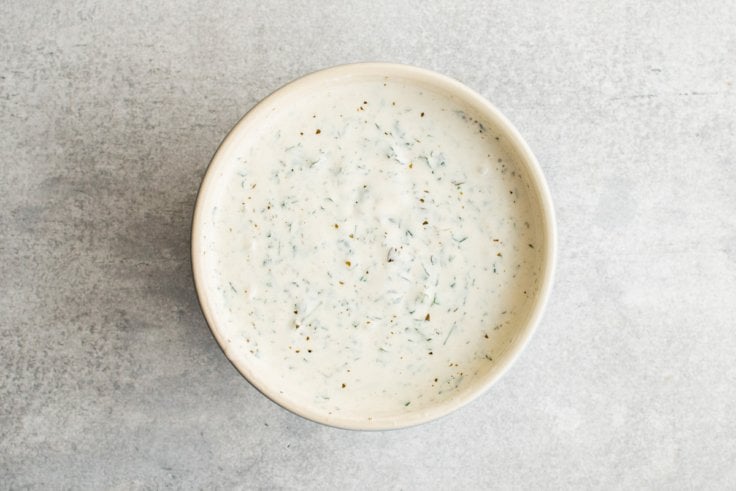 Creamy green goddess dressing in a bowl.