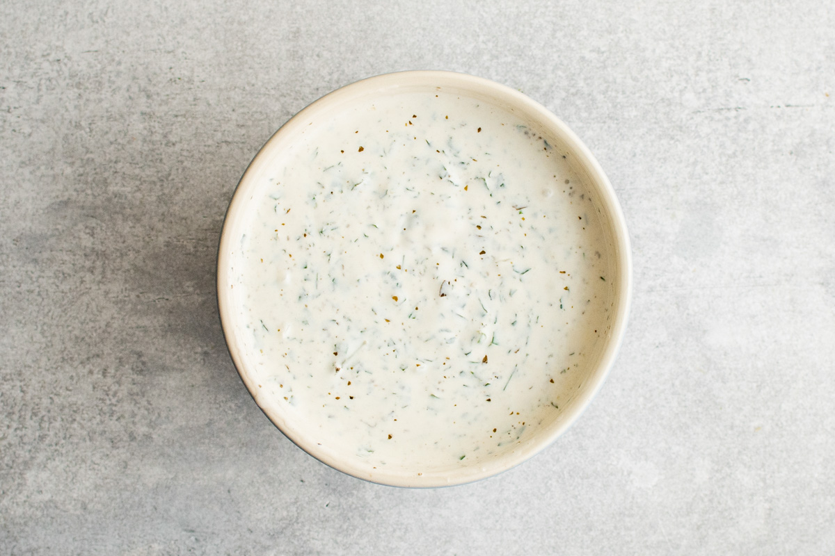 Creamy green goddess dressing in a bowl.