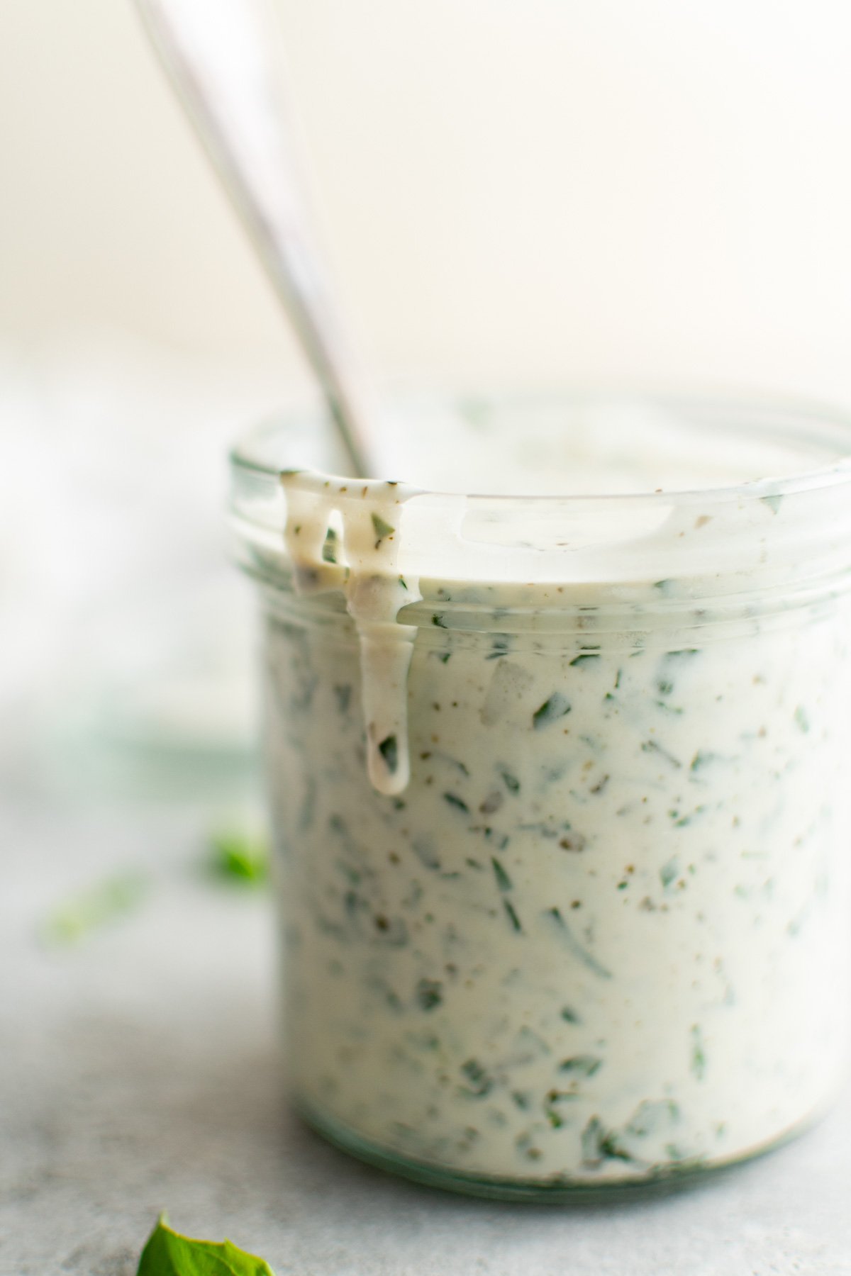 Jar with dressing dripping down the side.