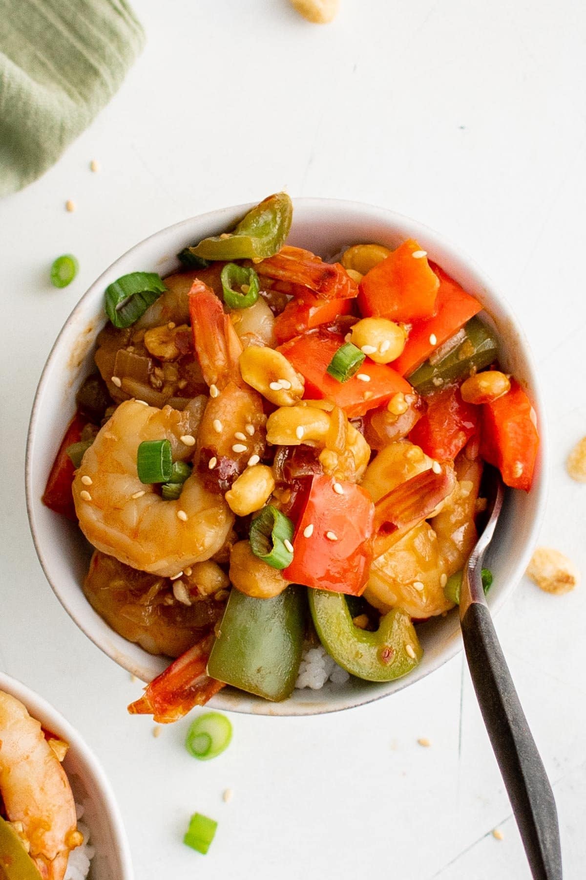 Kung Pao Shrimp in a small bowl with a spoon.