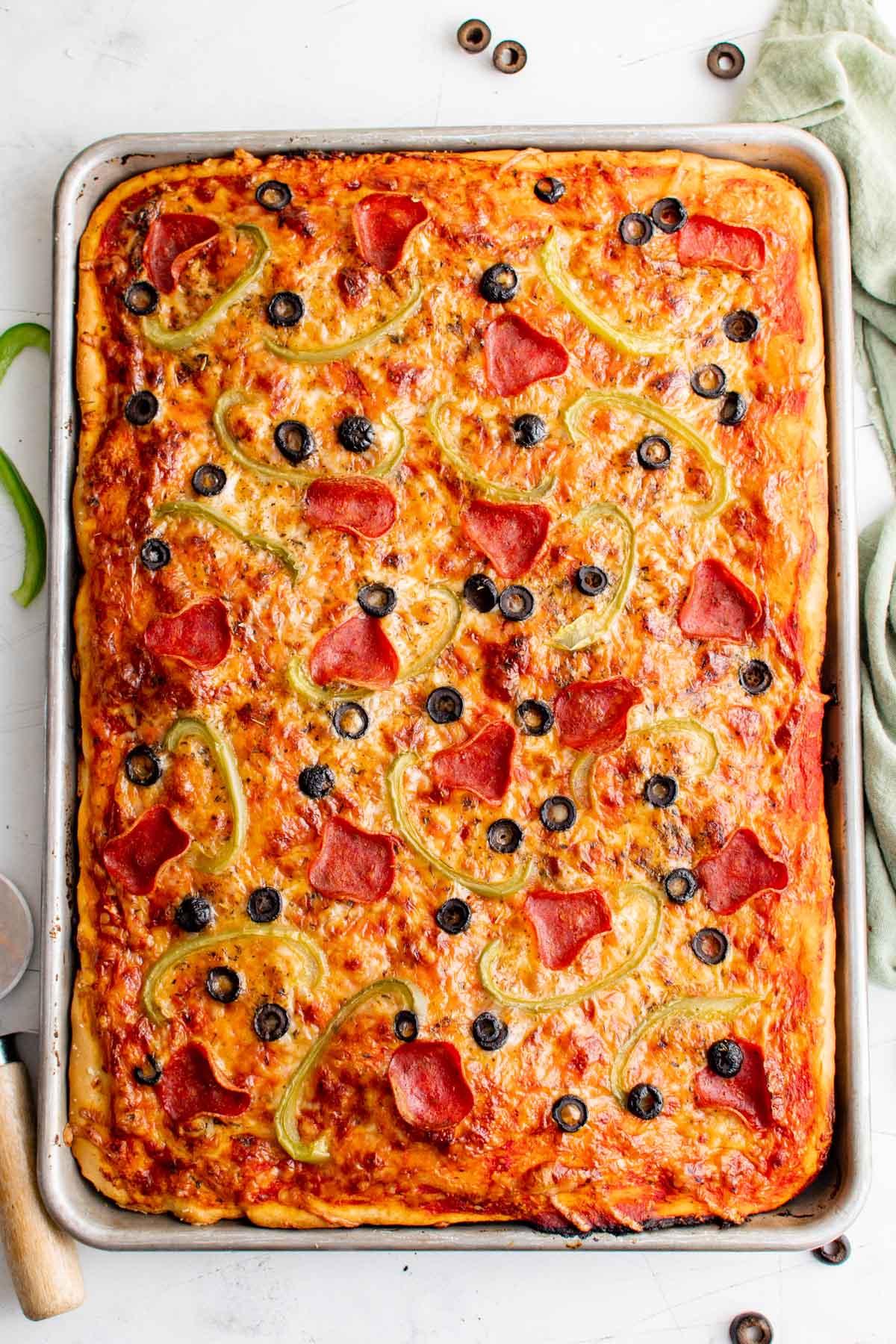Sheet pan pizza with olive, peppers and pepperoni. 