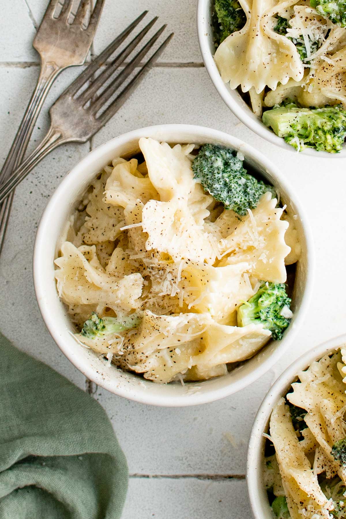 Bowl of broccoli pasta with 2 forks.
