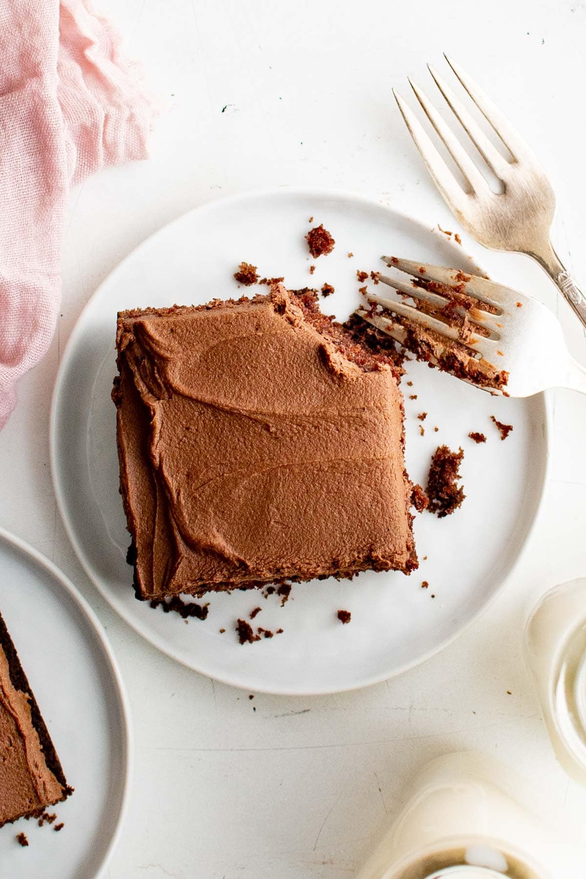 Slice of chocolate mayonnaise cake on a white plate with a fork. 