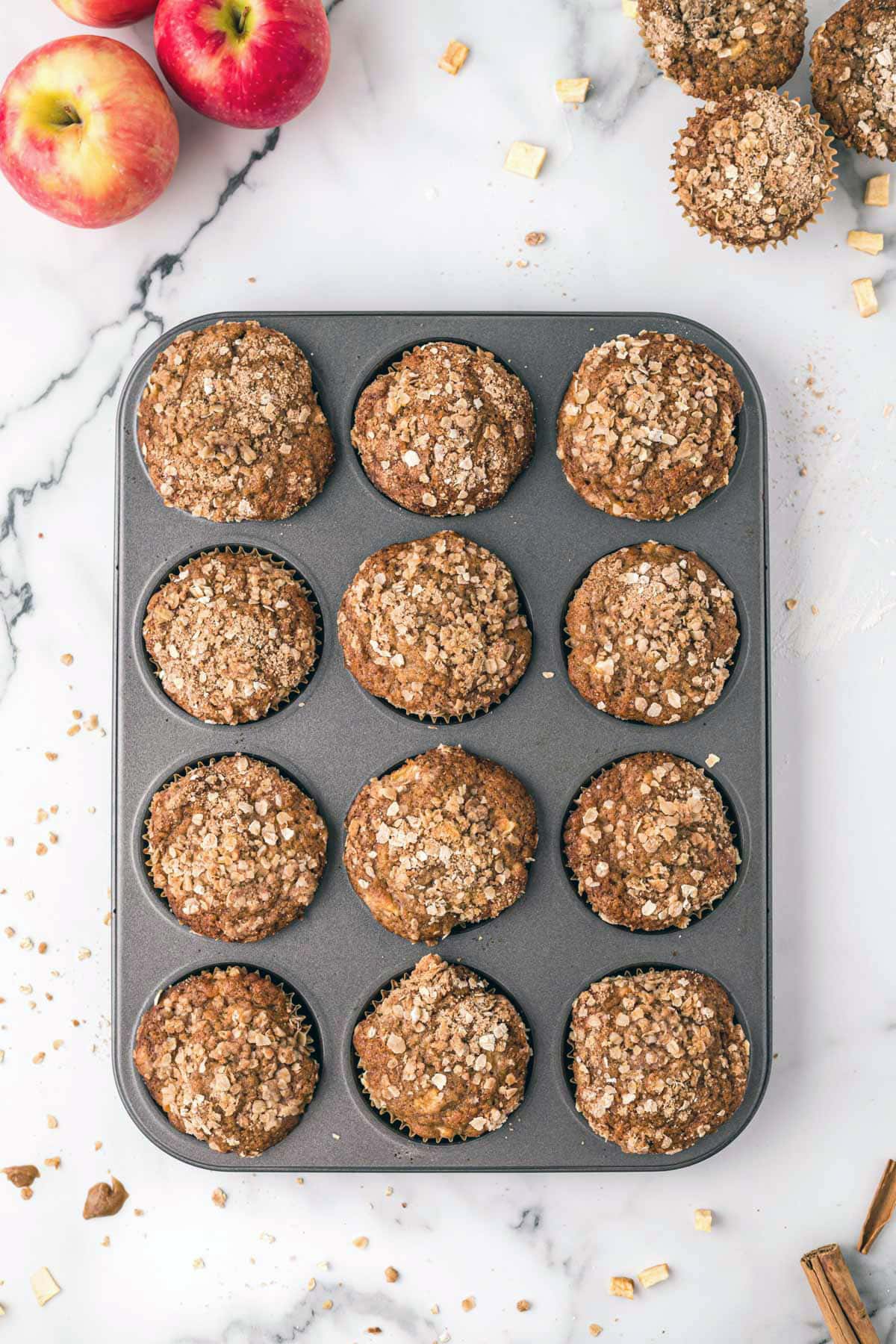 Baked apple muffins in a muffin pan.