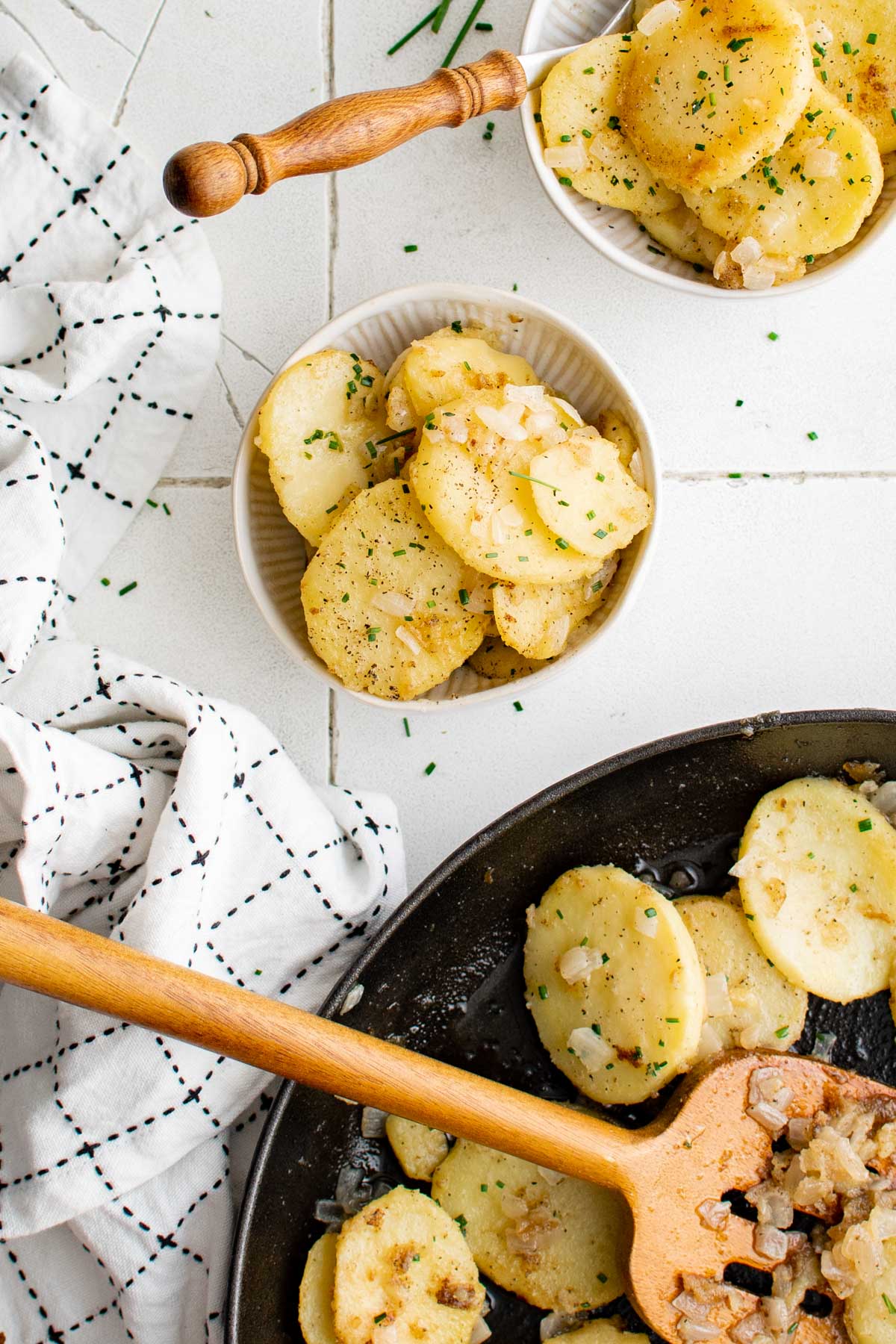 2 small plates with helpings of fried potatoes.