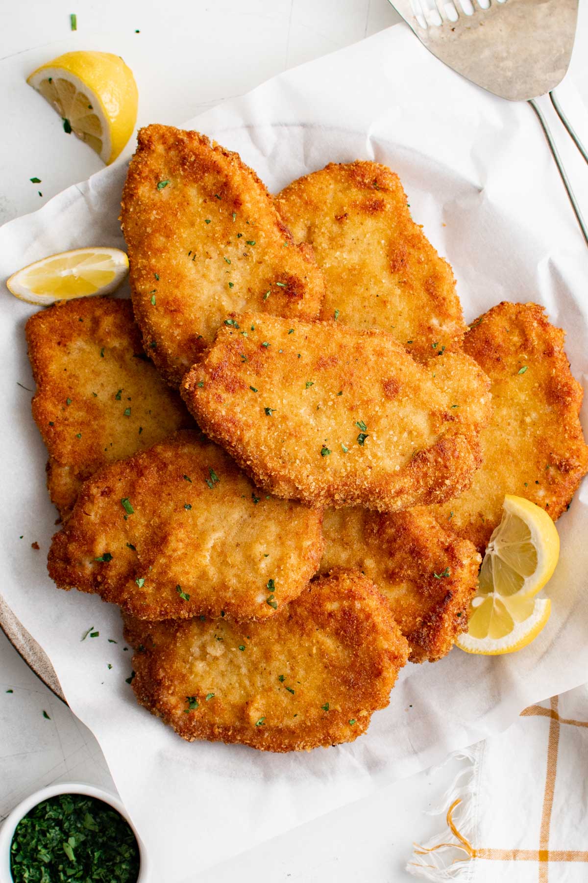 Breaded and fried crispy pork schnitzel on a platter. 