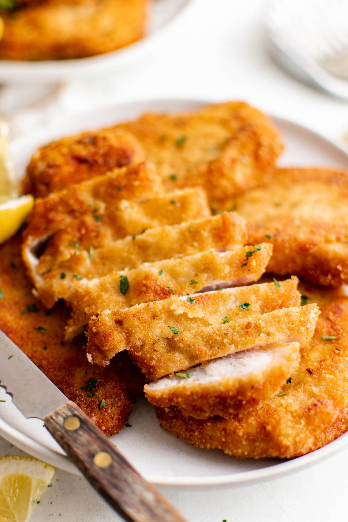 Slice breaded pork schnitzel on a plate.