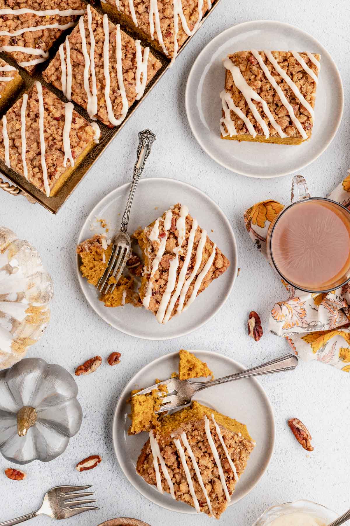 Small plates with pumpkin coffee cake and forks.