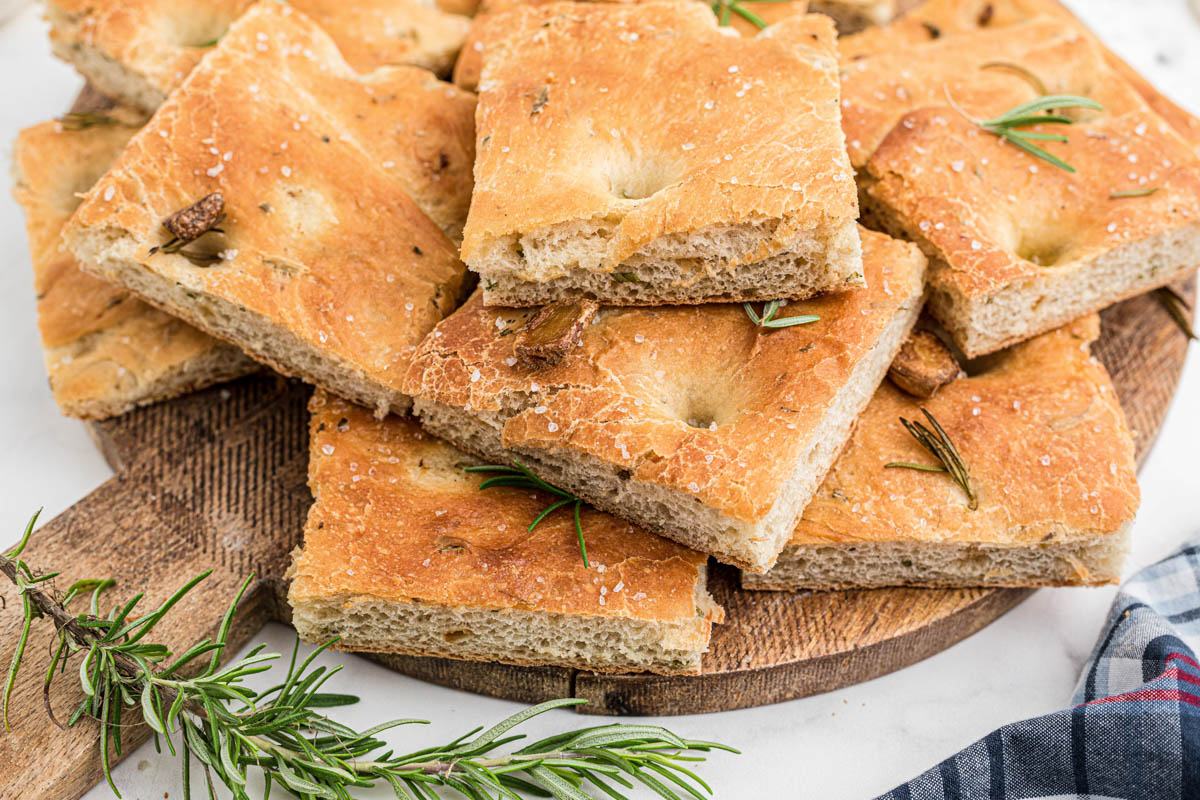 Side view of a stack of focaccia bread showing thr fluffy insides.