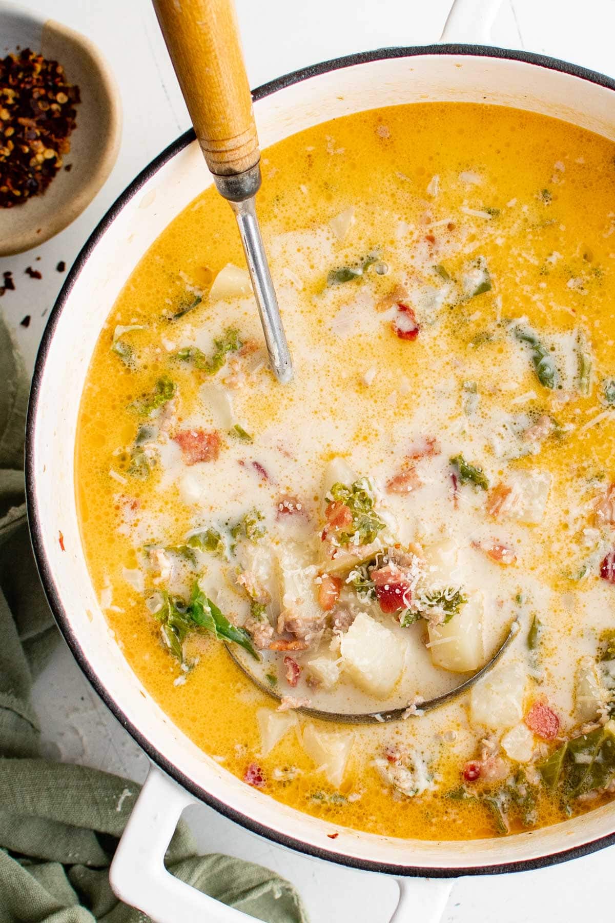 Zuppa Toscana soup in a pot with a ladle.