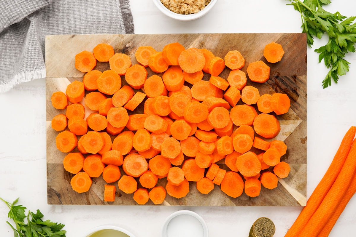 Chopped carrots on a wood cutting board.