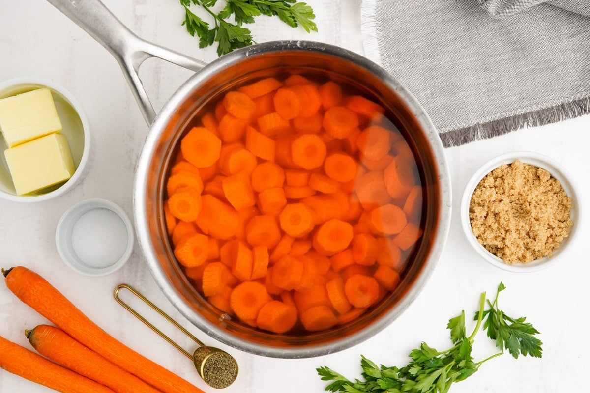 Sliced carrots in a pot of water.