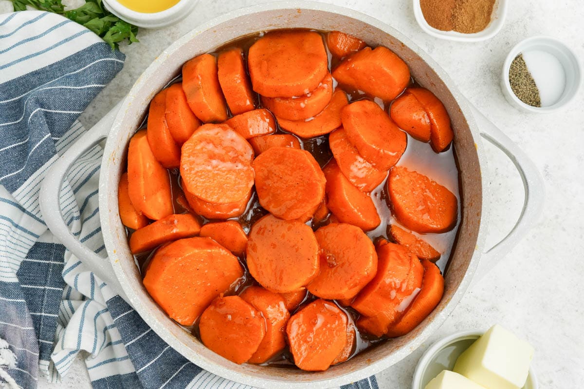 Sliced sweet potatoes in a brown sugar sauce.