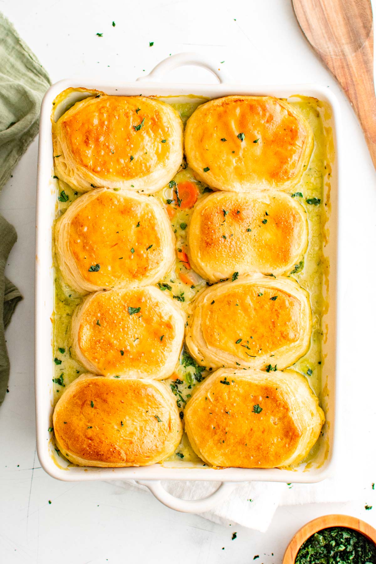 Baking dish with chicken pot pie and biscuits.