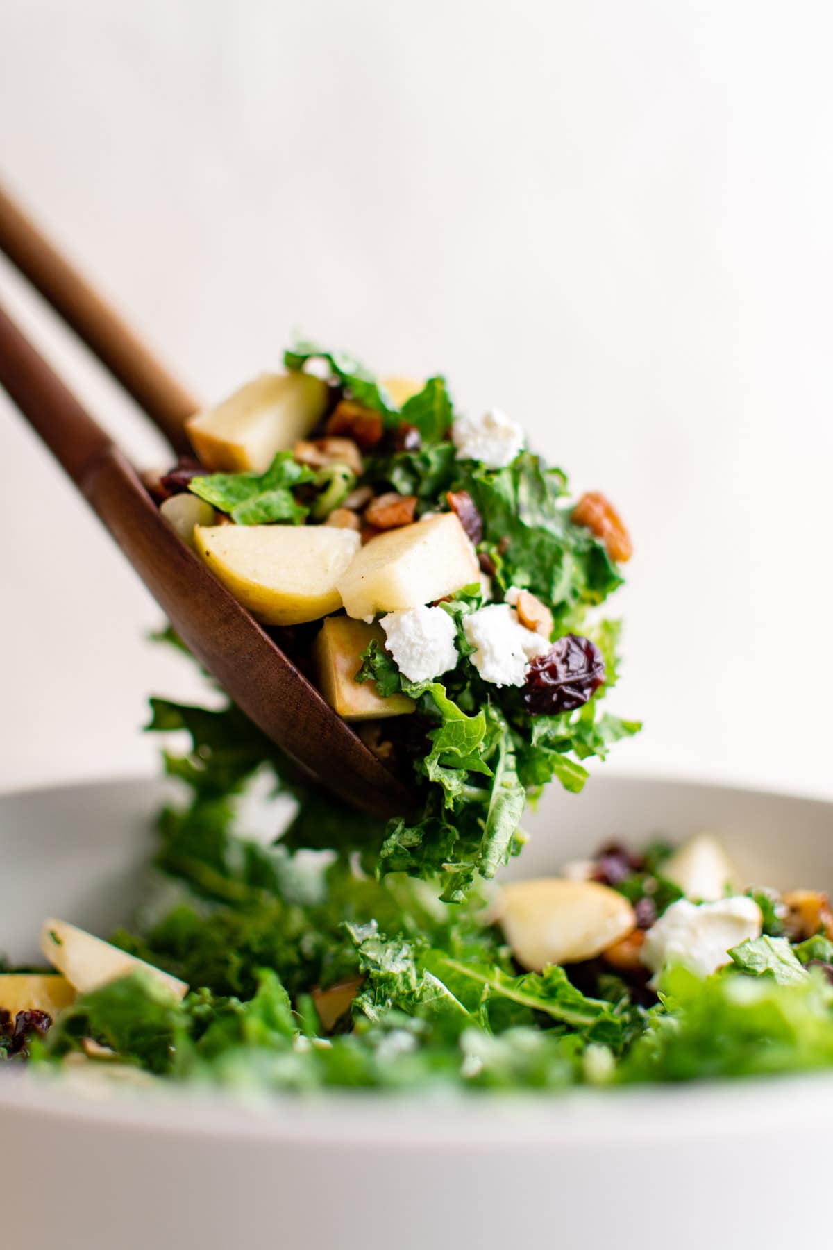 Kale salad with tongs.