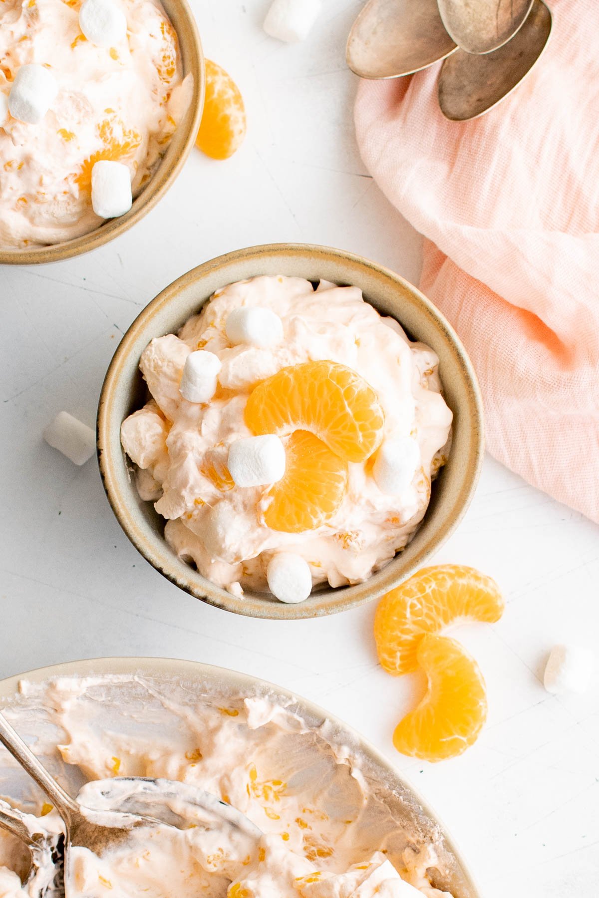 Mandarin oranges, orange jello salad in a bowl.