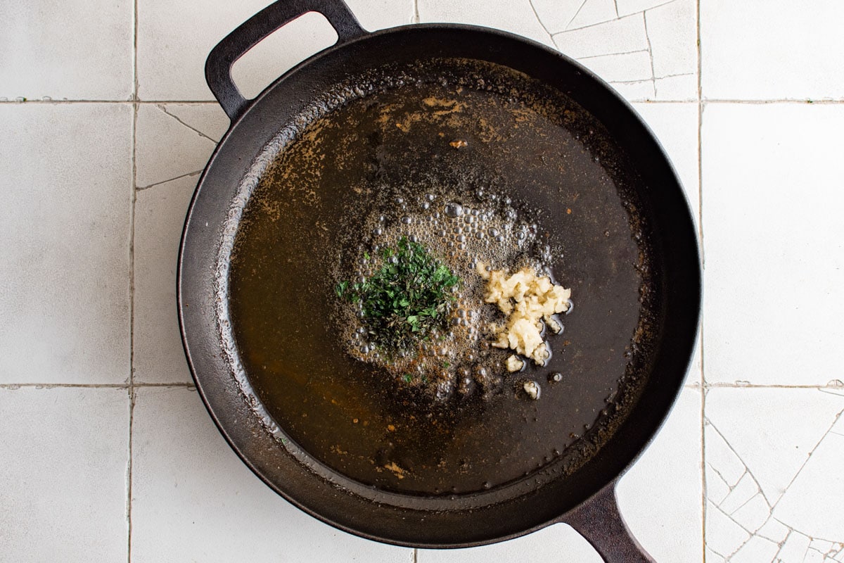 Melted butter, parsley, thyme and minced garlic in a cast iron skillet. 