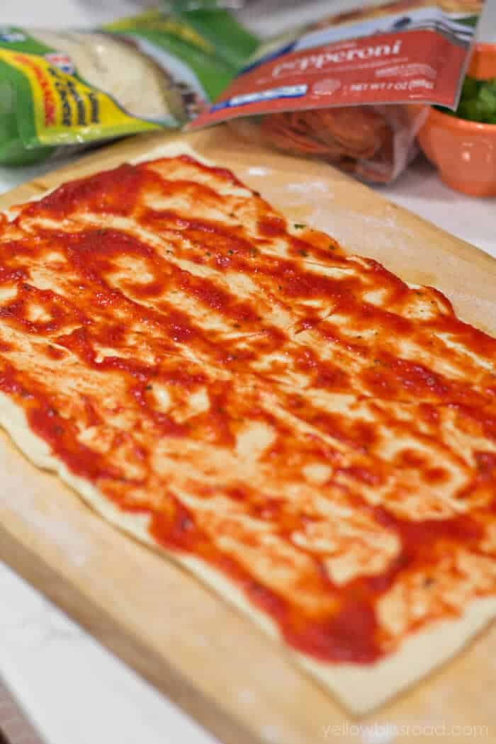 Rolled crescent dough with pizza sauce.