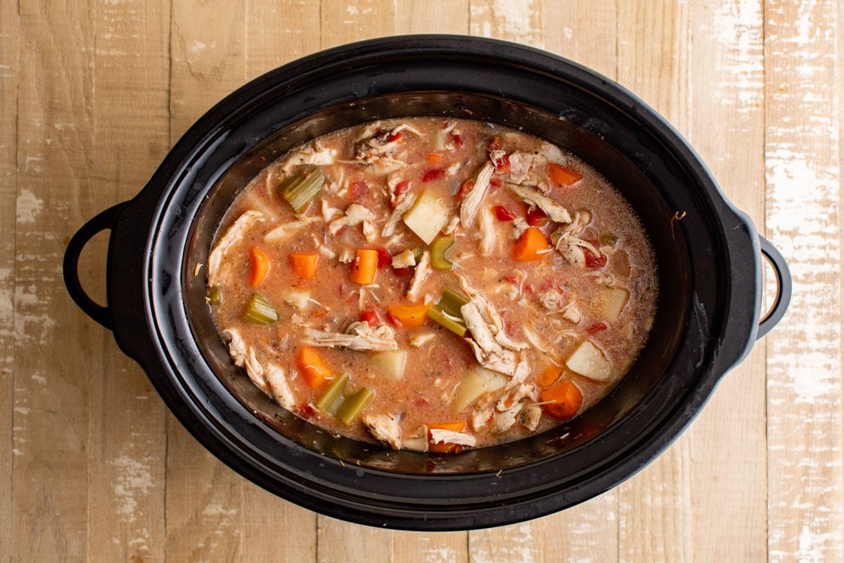 Creamy chicken stew in a slow cooker pot.