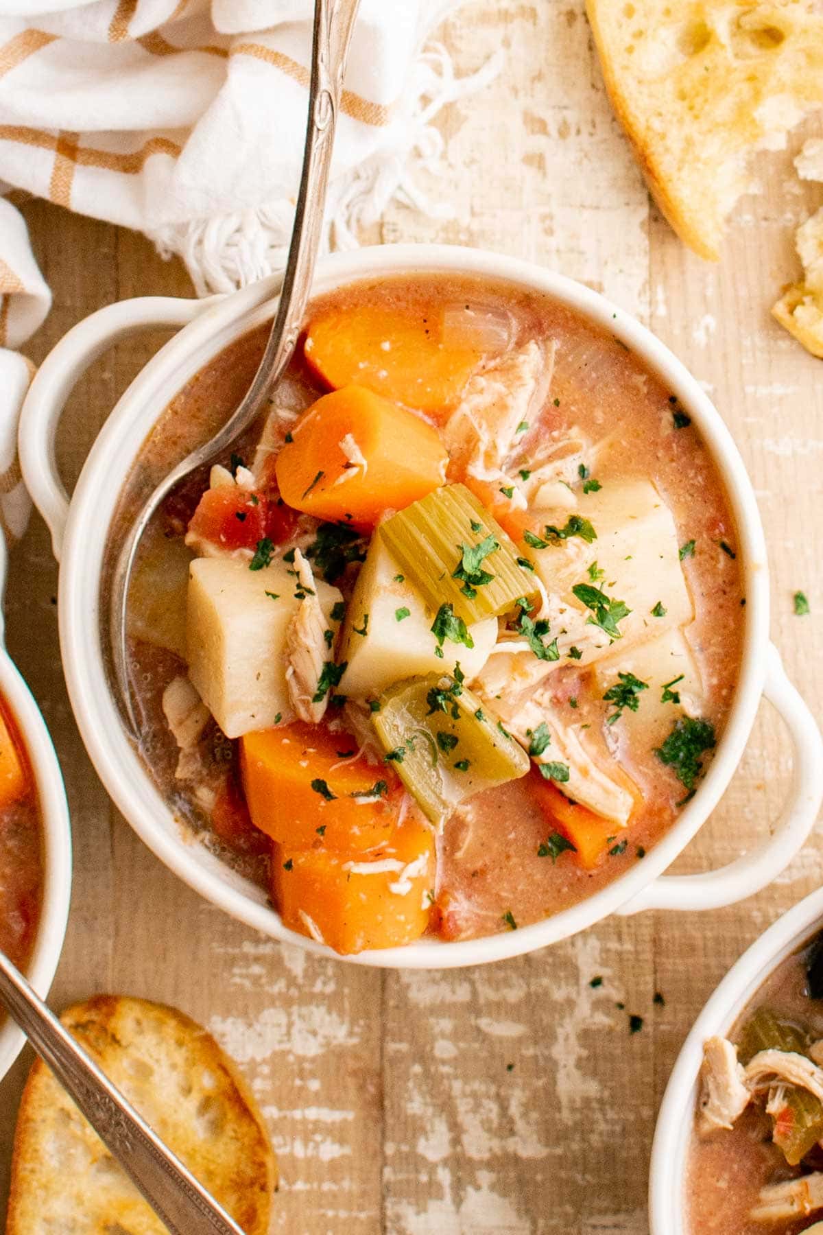 Bowl of chicken stew with a spoon.