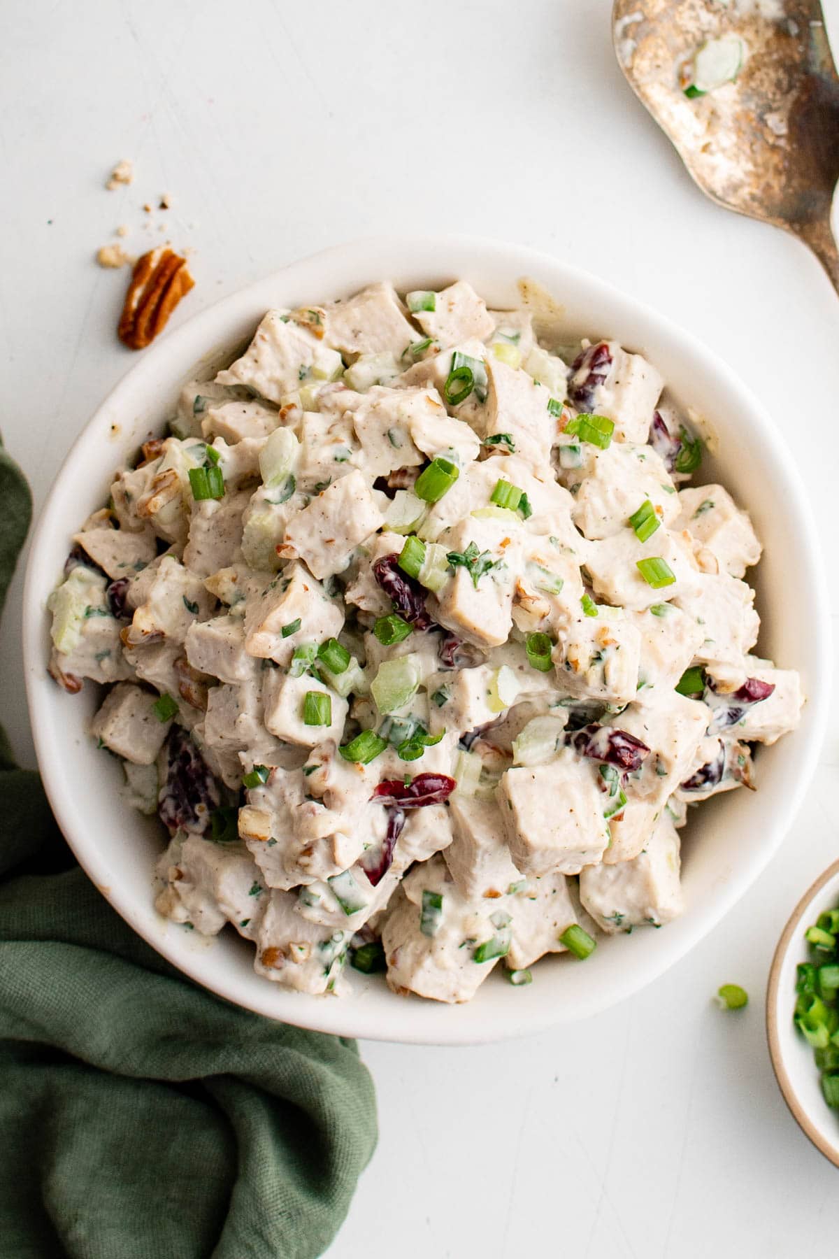 Bowl filled with a batch of turkey salad with mayo.