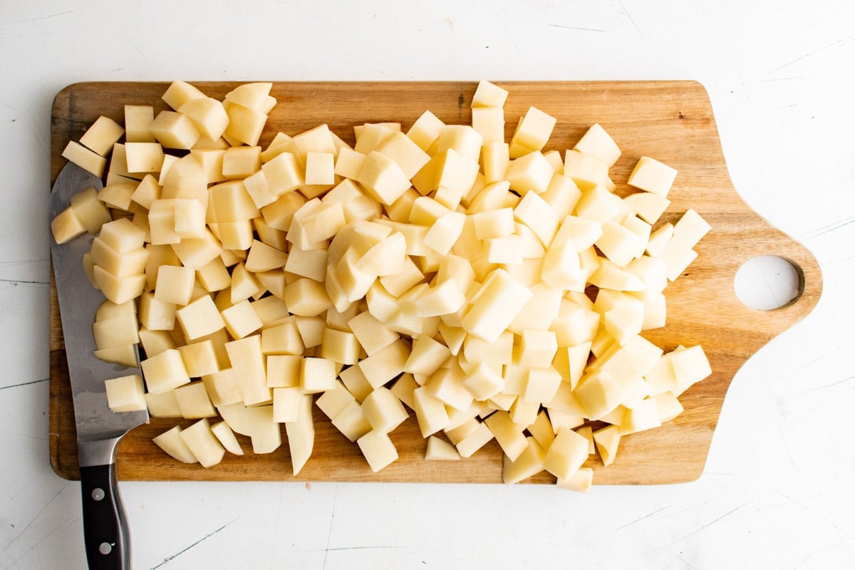 Cubed potatoes on a cutting board.