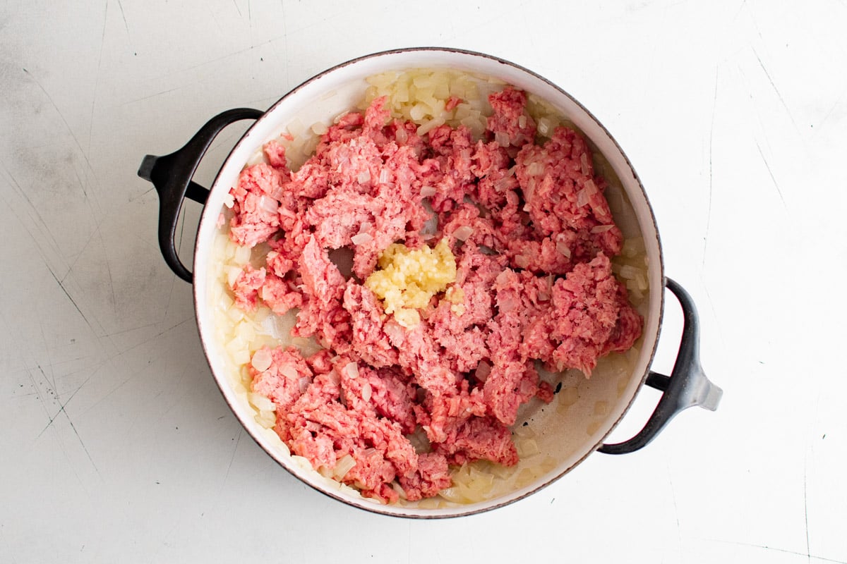 Ground beef, garlic and onions in a soup pot.