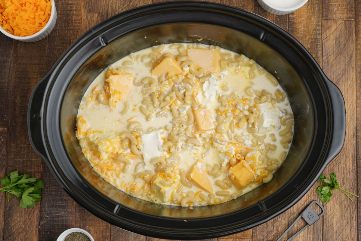 Macaroni, cheese, and evaporated milk in a slow cooker.