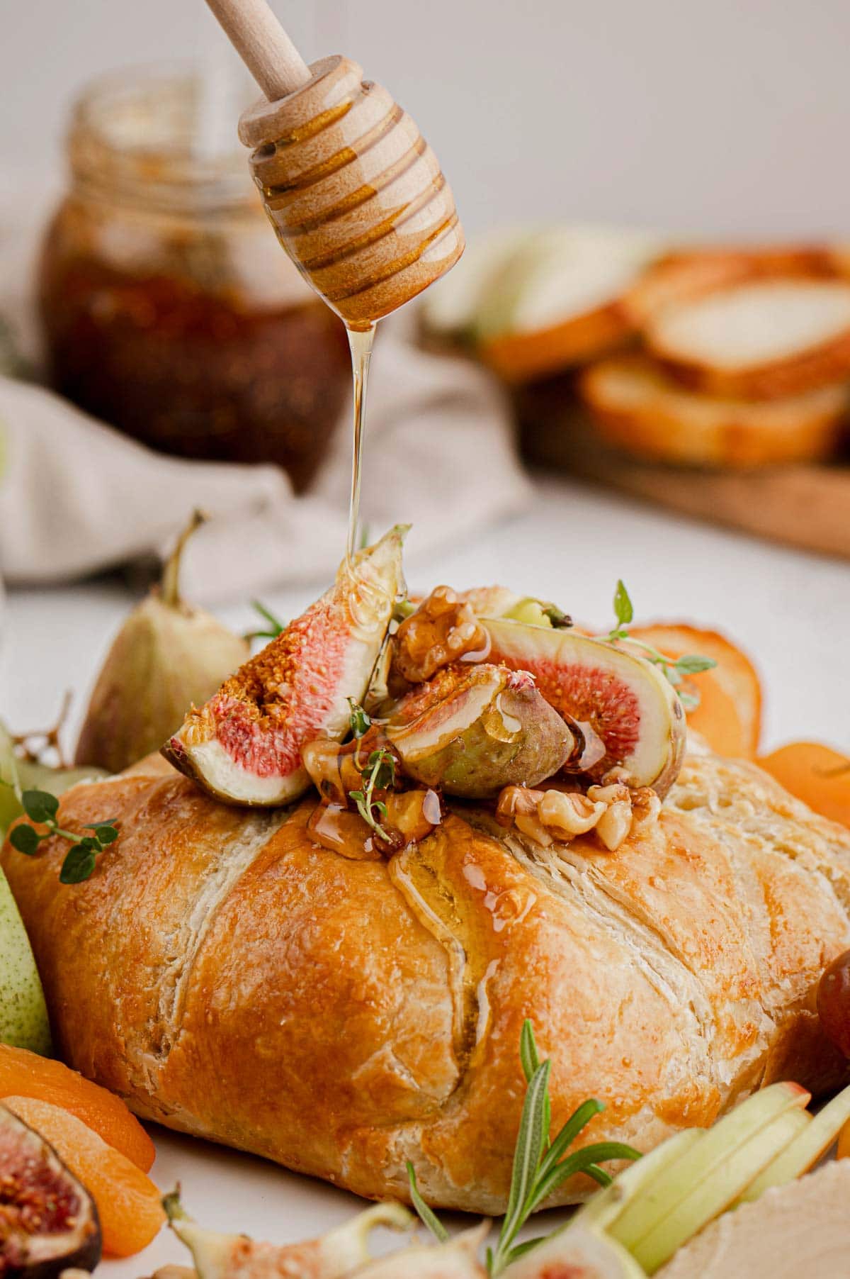 Puff Pastry wrapped brie with quartered figs, apple slices and honey.