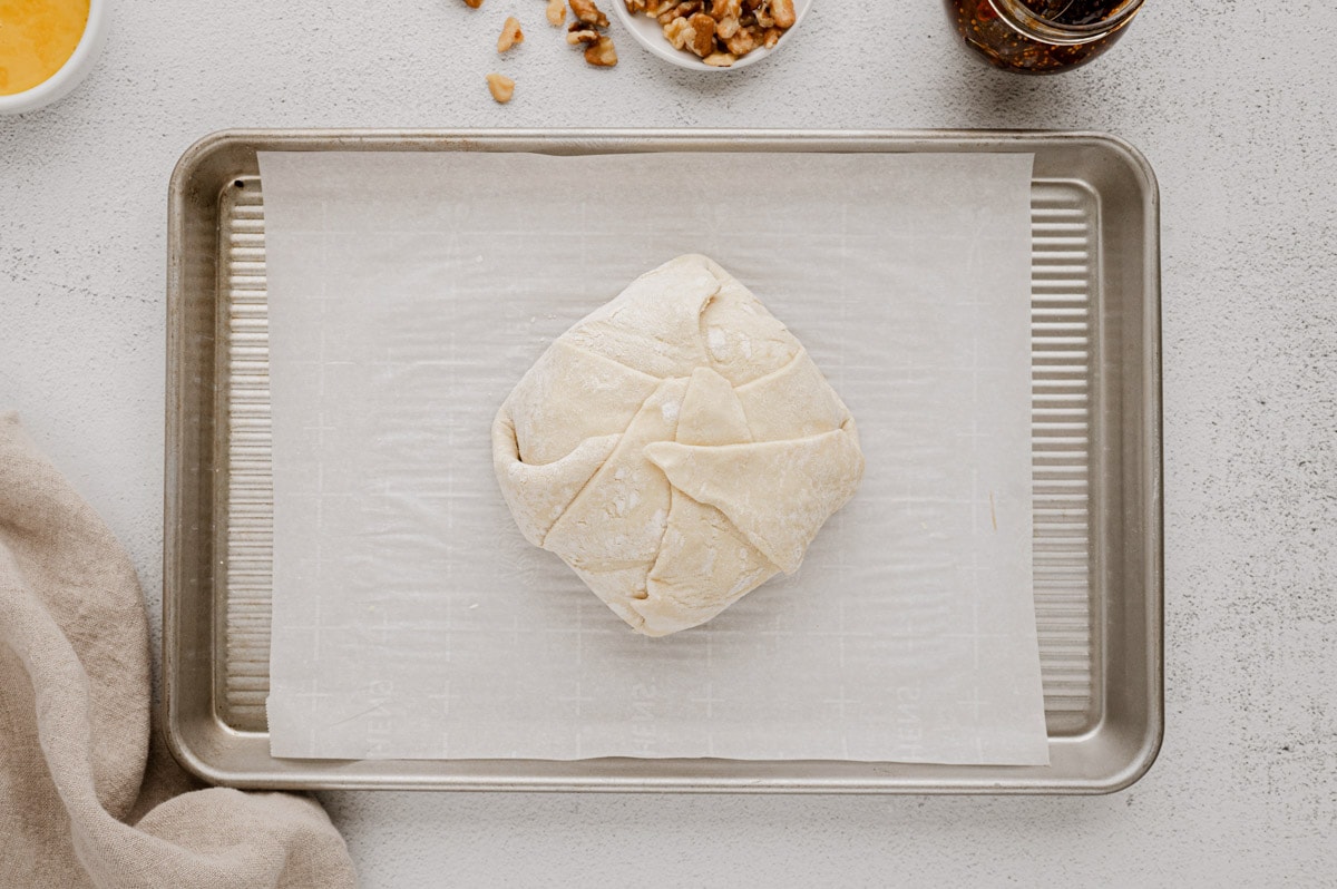 Puff pastry wrapped up around a wheel of brie cheese.