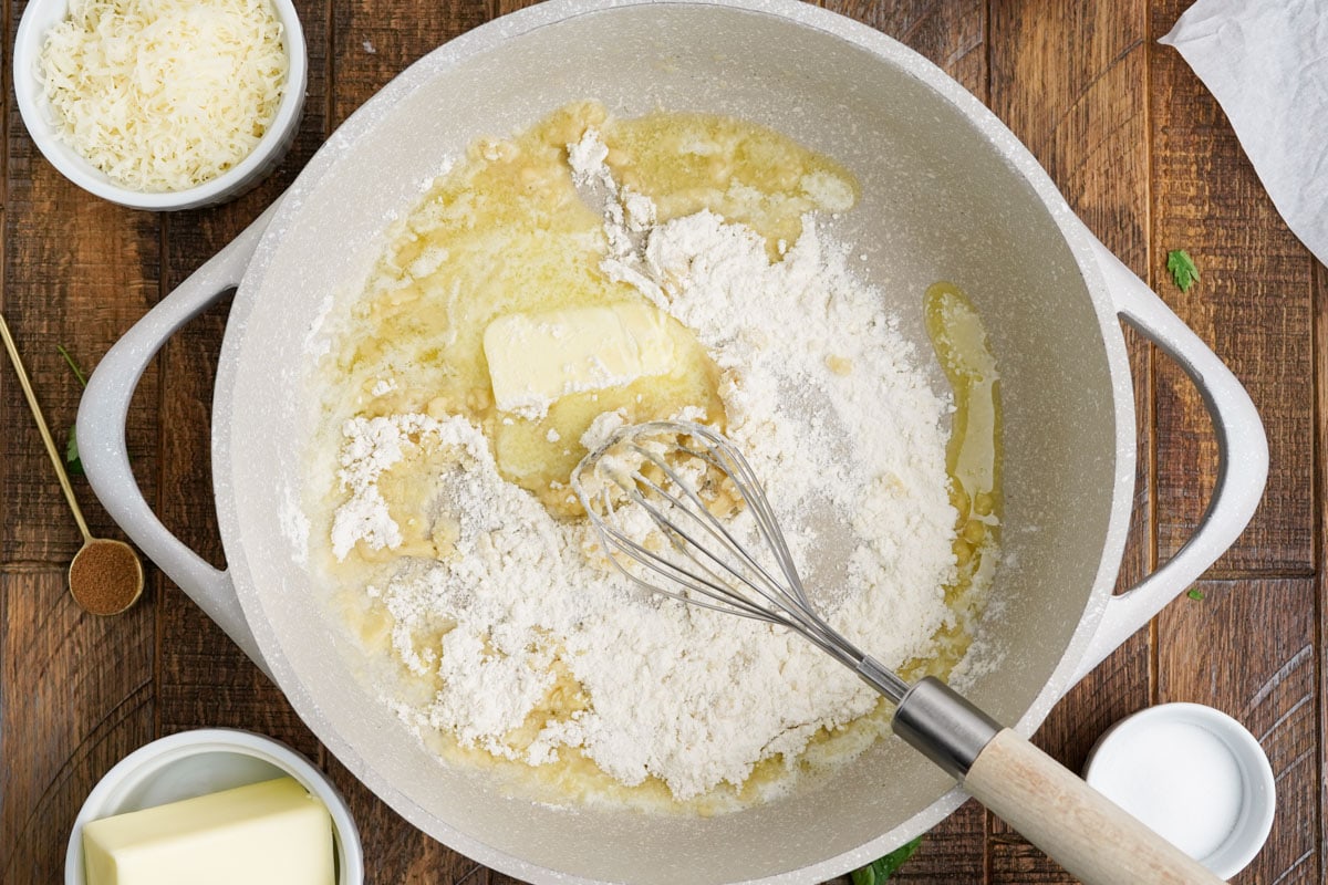 Melted butter and flour in a saucepan with a whisk.
