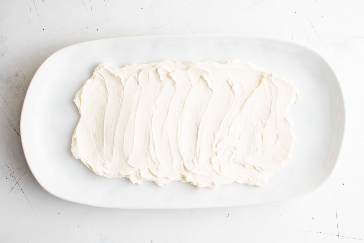 Cream cheese spread on a large white platter.