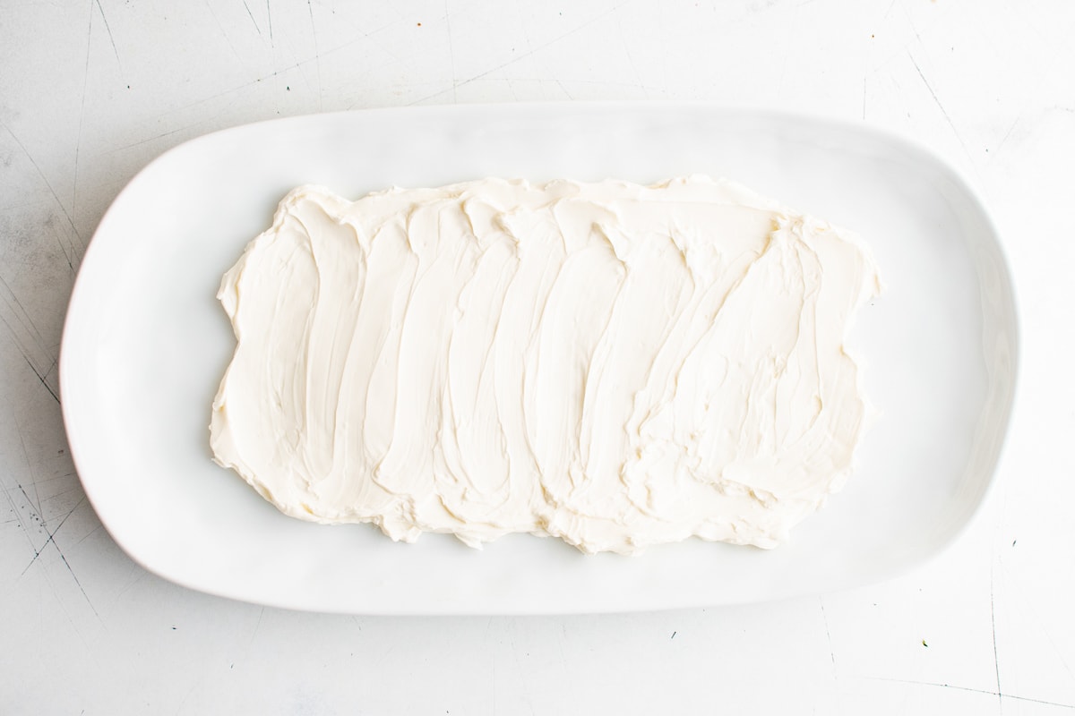 Cream cheese spread on a large white platter.