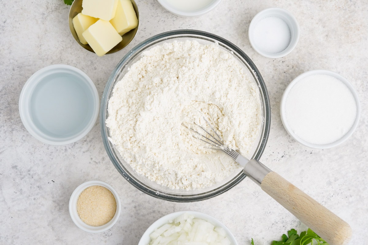 Flour in a large mixing bowl with a whisk.