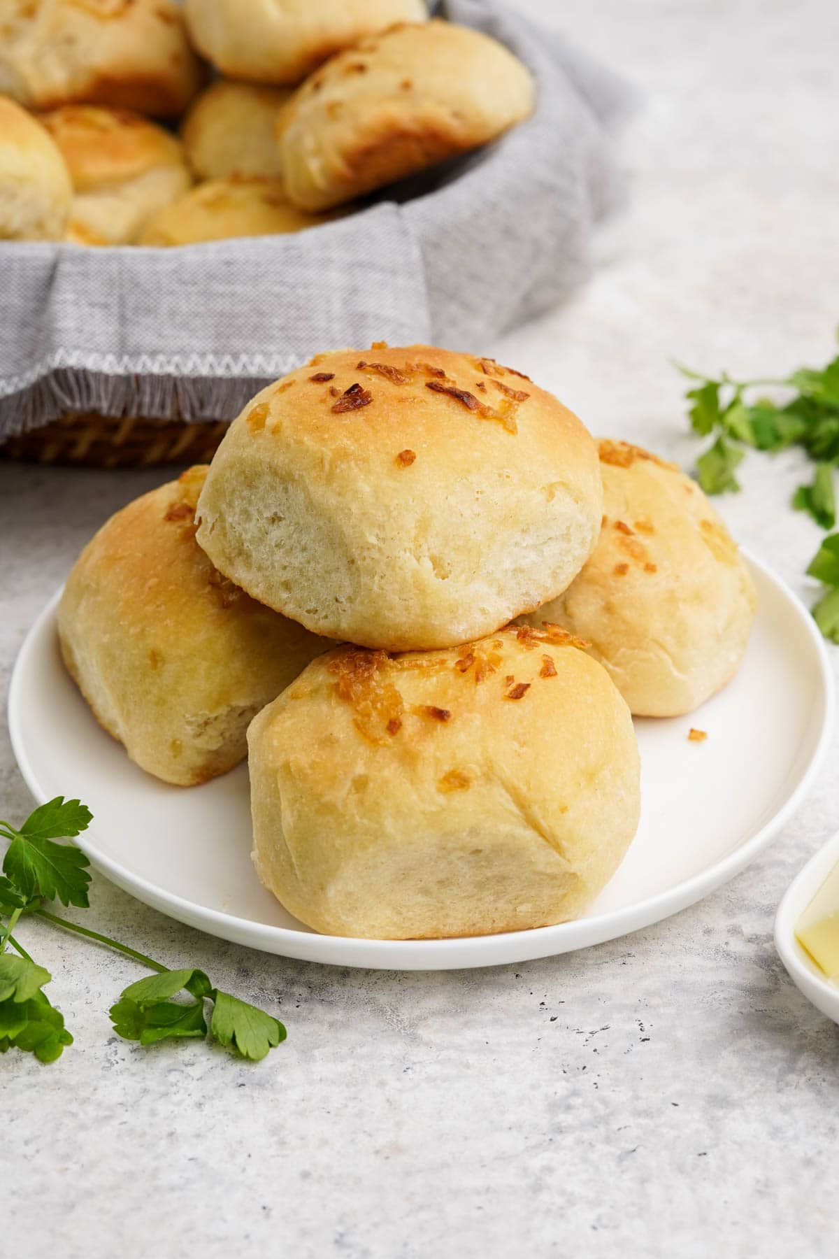 Onion Rolls in a small stack on a white plate.