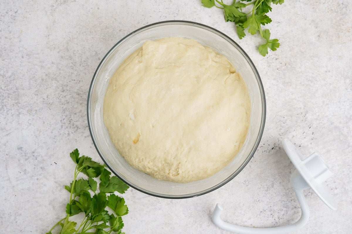 Dough that has been kneaded in a large bowl.