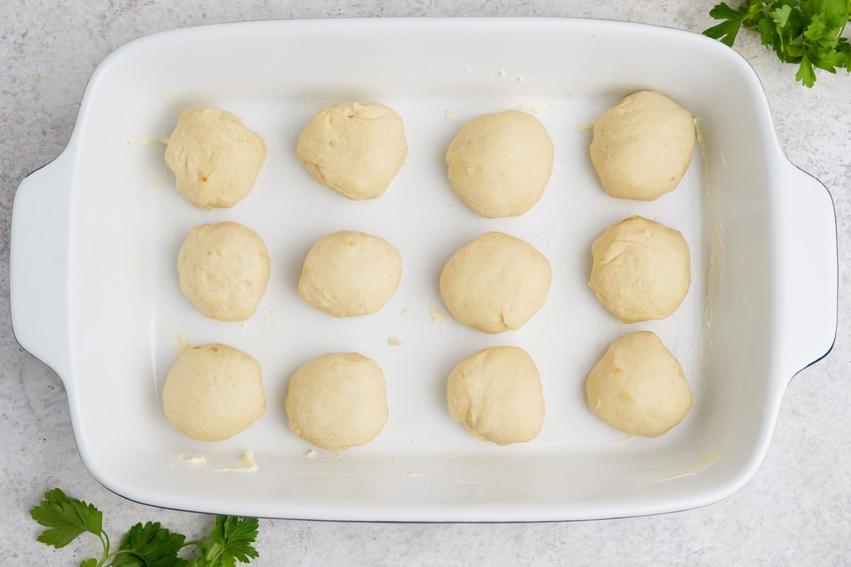 Balls of dough in a baking dish.
