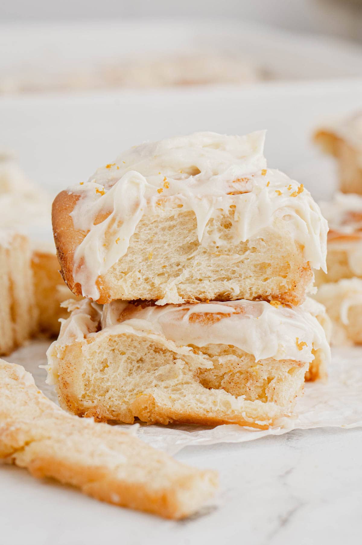 Two orange rolls staked on top of each other.