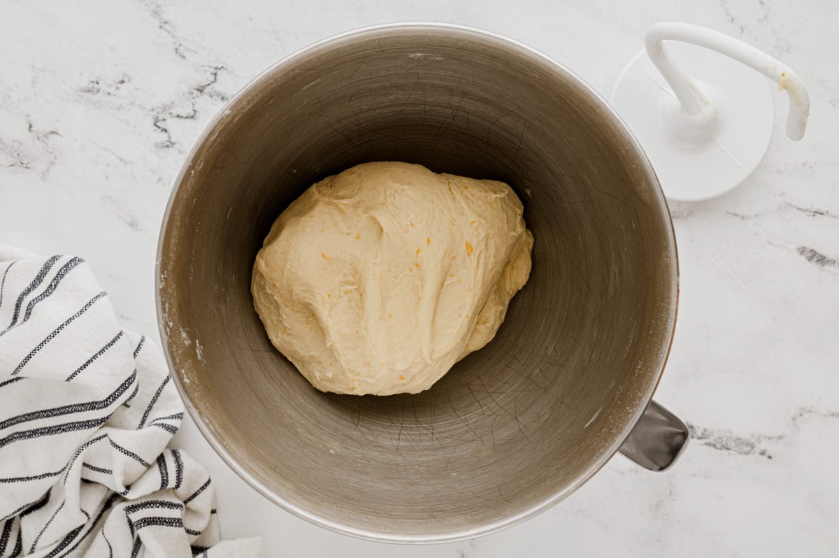 Ball of dough in a stand mixer bowl.