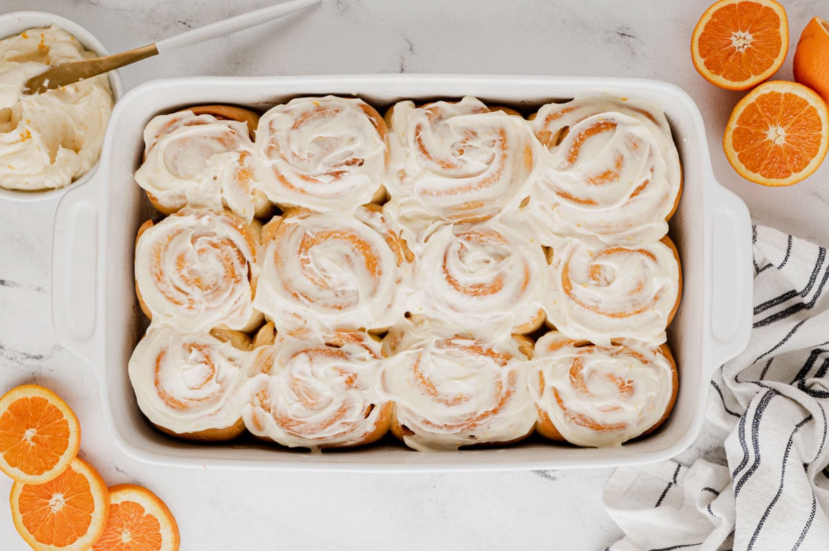 Frosted Orange Rolls in a baking dish. 