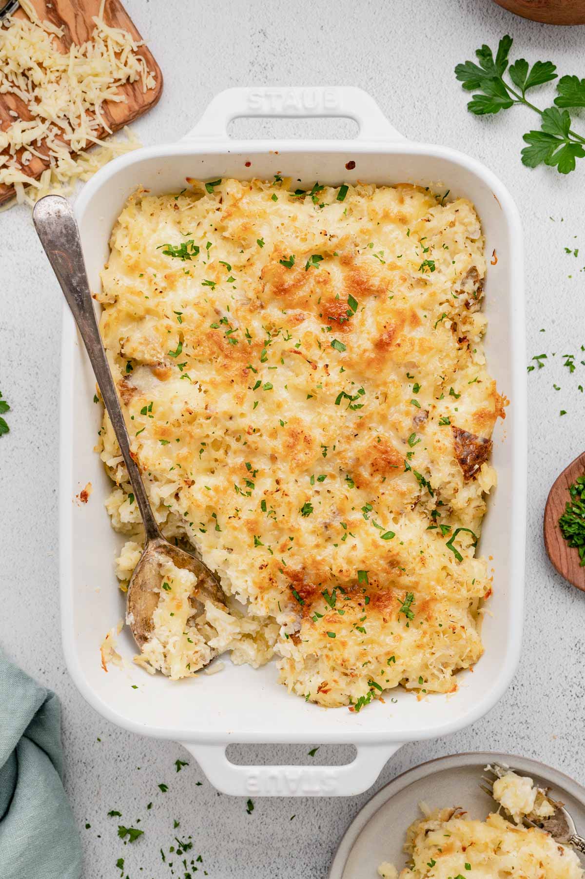 Potatoes Romanoff casserole in a white baking dish.