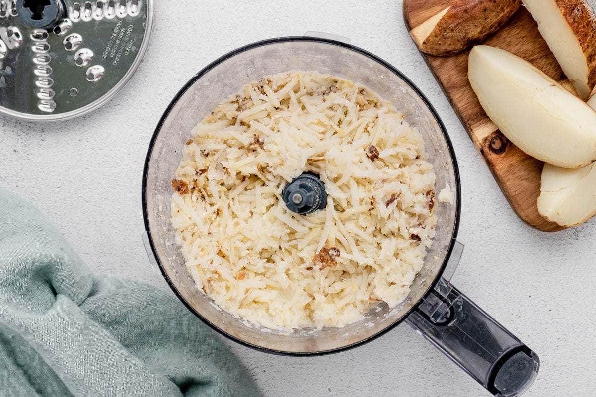 Grated potatoes in a food processor.