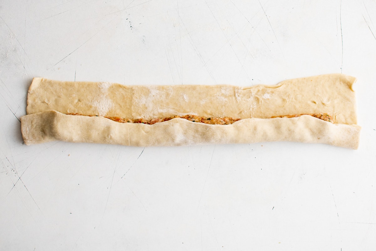 Ground sausage form into a log on some puff pastry.