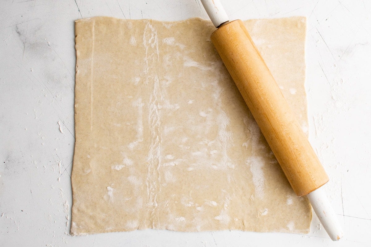 A sheet of puff pastry, rolled out with a rolling pin.