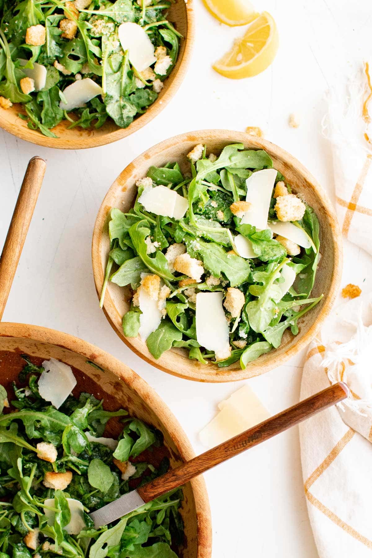 Arugula salads in bowls with forks.